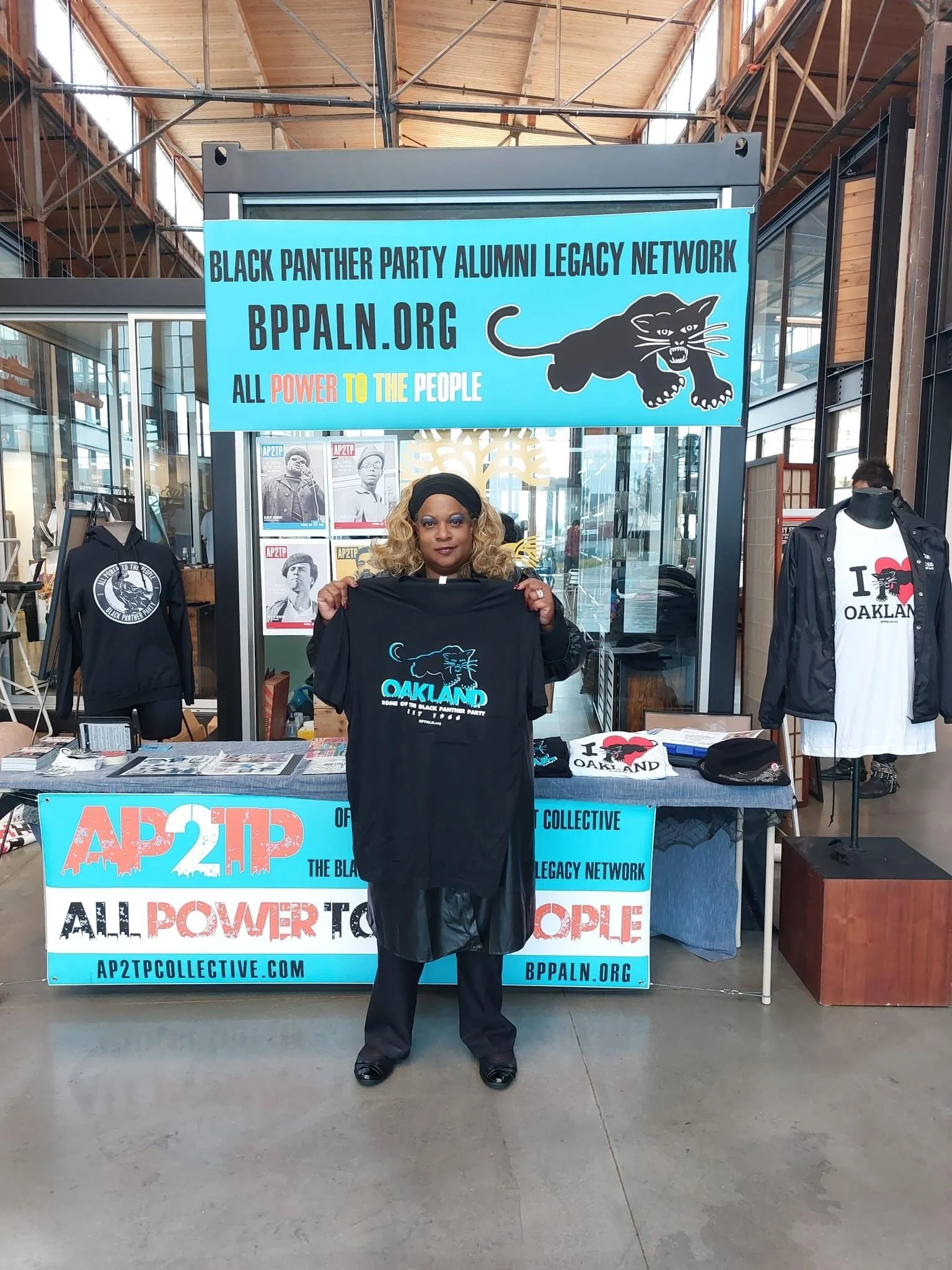 Dr Zafirah Ned holds the Oakland Home of the Panthers T-Shirt