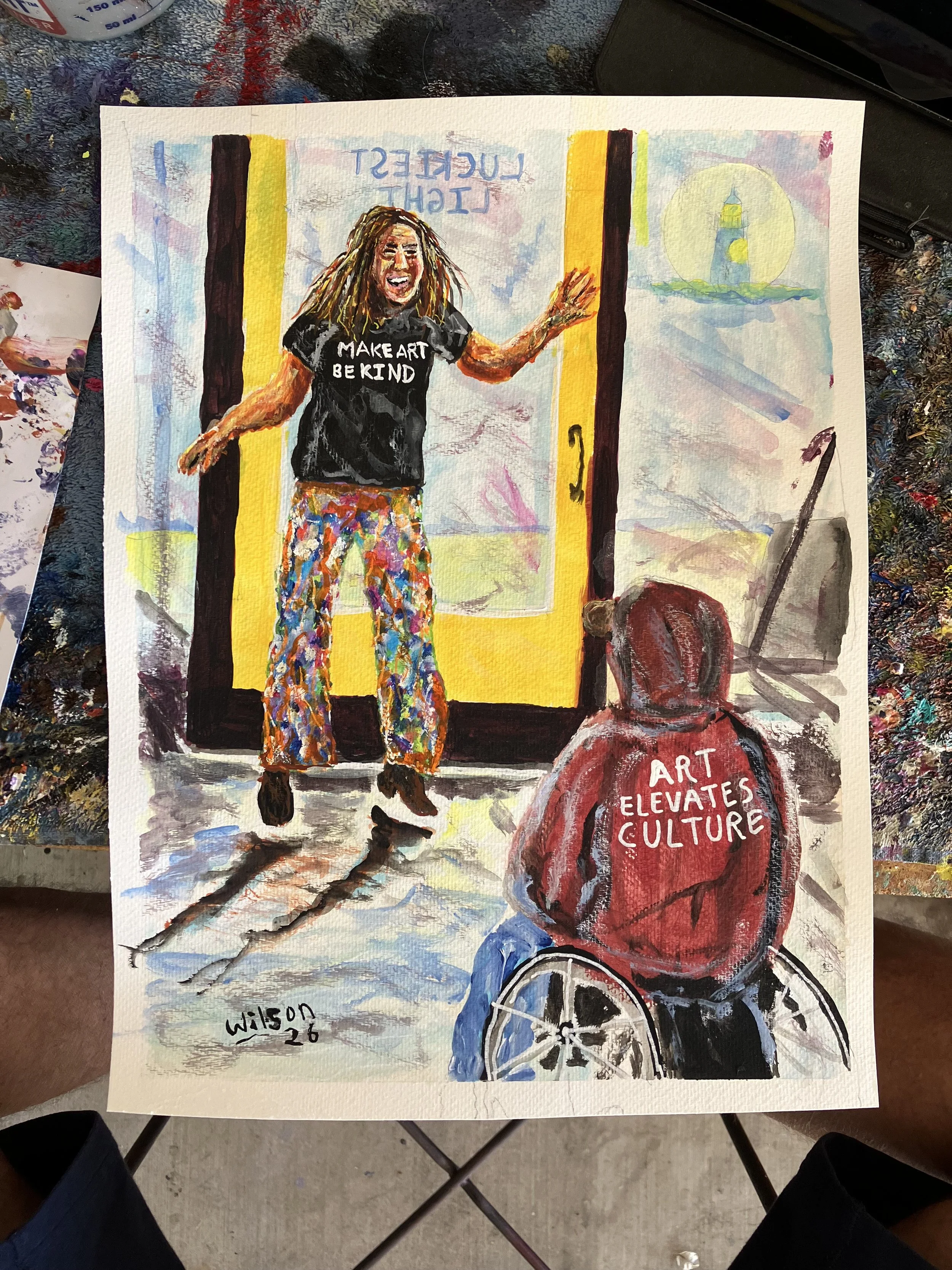 A colorful watercolor painting of a woman with curly hair, wearing a black T-shirt that reads "MAKE ART BE KIND," and patterned pants, standing in front of a door with yellow and black borders. There is a man in a wheelchair in the foreground with a red hoodie that reads "ART ELEVATES CULTURE," and a landscape with a lighthouse painted in the background, as well as text that appears to be upside down.
