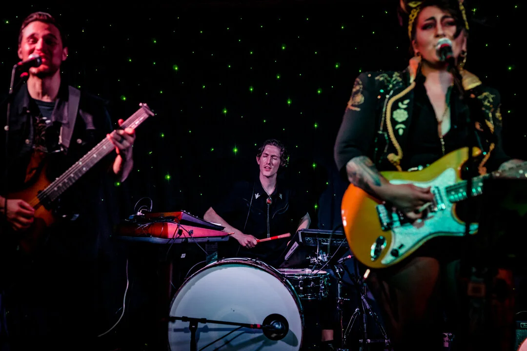 Sitting in the back, Andrew doesn't get as much attention from the camera, but he runs the heartbeat of everything we do; running a sequencer and an electronic kit all while playing his drum set. He's our booper. We make pop music really, but doing o