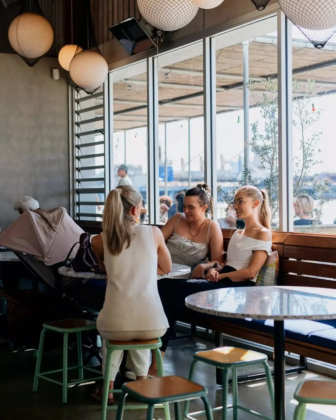 Tables filled with friends, cocktails glistening in the sun and the calm of the river just a few steps away.