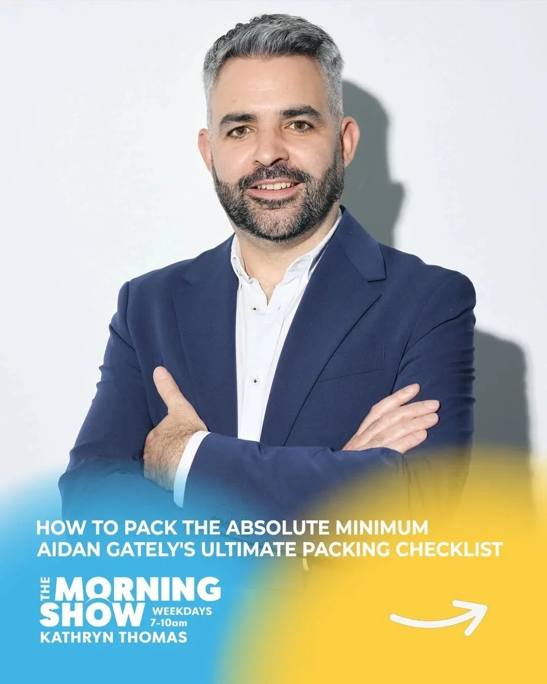 Image shows Declutter Expert Aidan Gately stannic smiling at the camera wearing a white shirt ad navy blazer. His arms are folded and his hair is black/grey. And underneath it says: How to pack the absolute minimum
