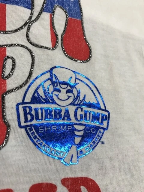 Close up of foil logo and distressed soft ink with gel glitter. 