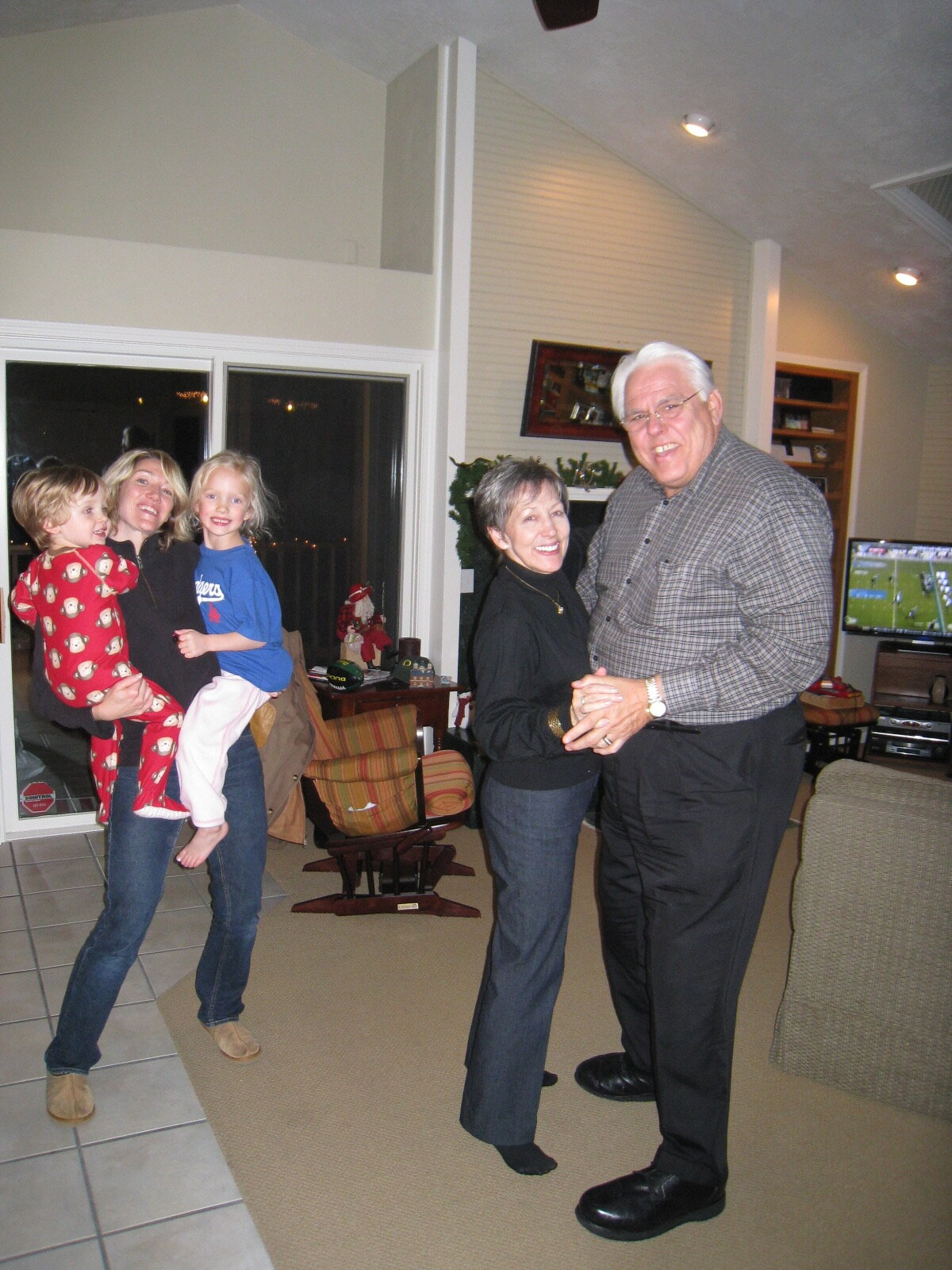 J Jon Bruno dancing with his wife Mary, daughter-in-law, and grandchildren