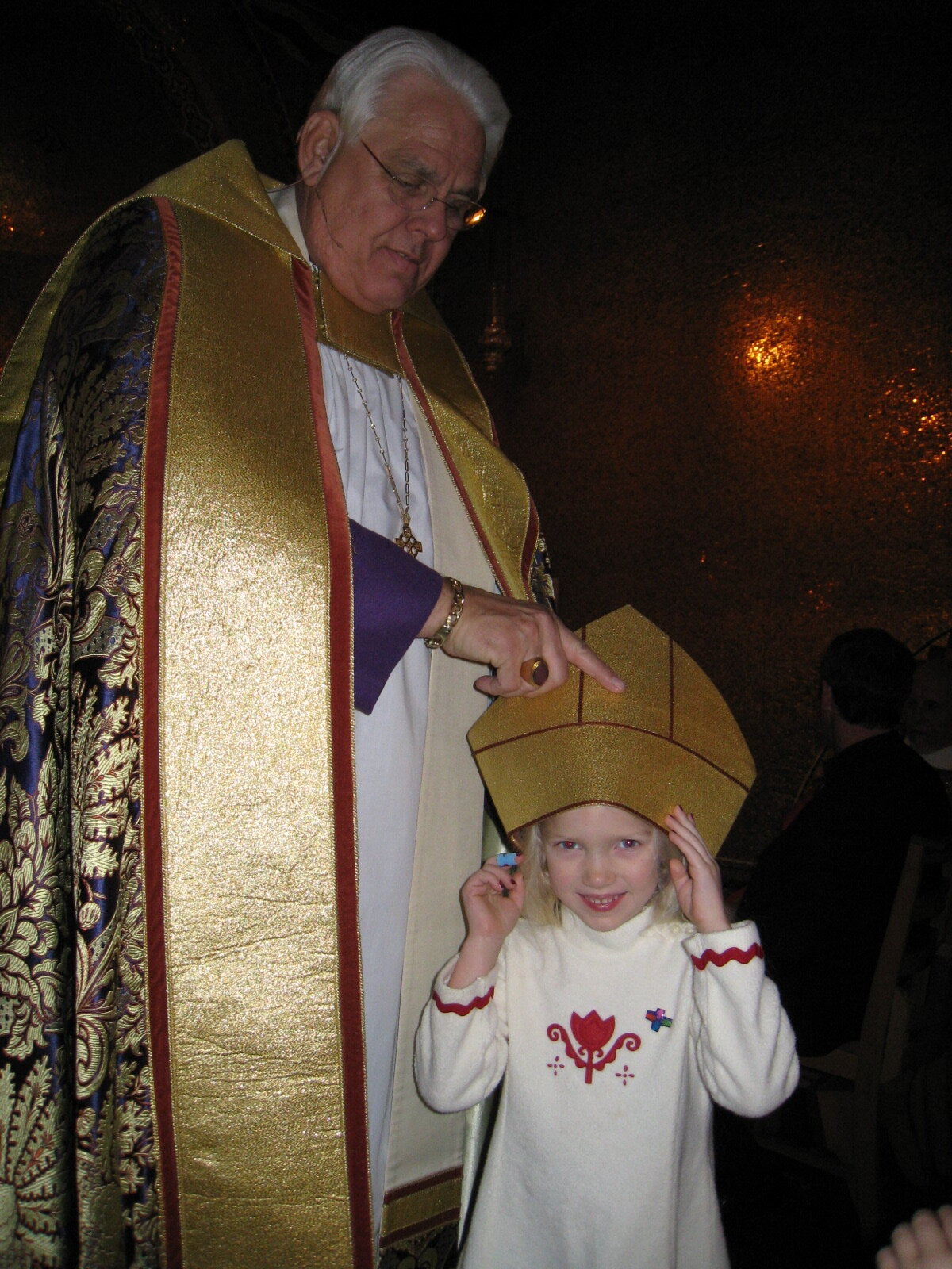 Rt. Rev. J Jon Bruno sharing his mitre with his granddaughter 
