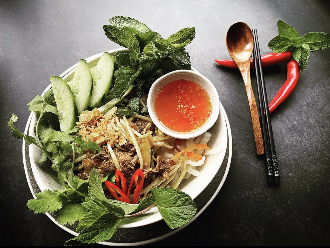 Vermicelli lemongrass noodle, marinated rib eye beef with fresh herbs and homemade fish sauce