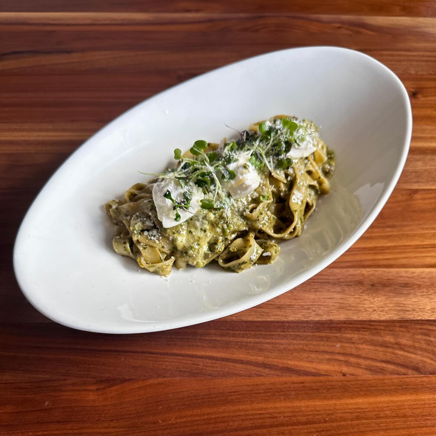 The Pesto Burrata features our house made pesto of pistachios, Parmesan cheese, garlic and fresh basil, topped with chunks of burrata and microgreens. Available with fettuccine or bucatini &ndash; either way it&rsquo;s delicious!