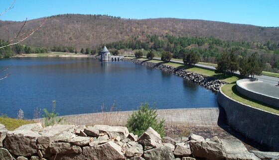 The Saville Dam was completed in 1940 on the East Branch of the Farmington River. It is named for the chief engineer of the project, Caleb Mills Saville. The Barkhamsted Reservoir is about 8 miles long and extends from central Barkhamsted north int
