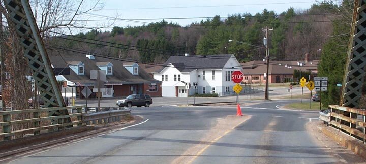 A view of Pleasant Valley taken from the bridge over the Farmington River. At left is the Pleasant Valley General Store. The white building is the Barkhamsted Town Hall and at right is a portion of the Barkhamsted Elementary School.