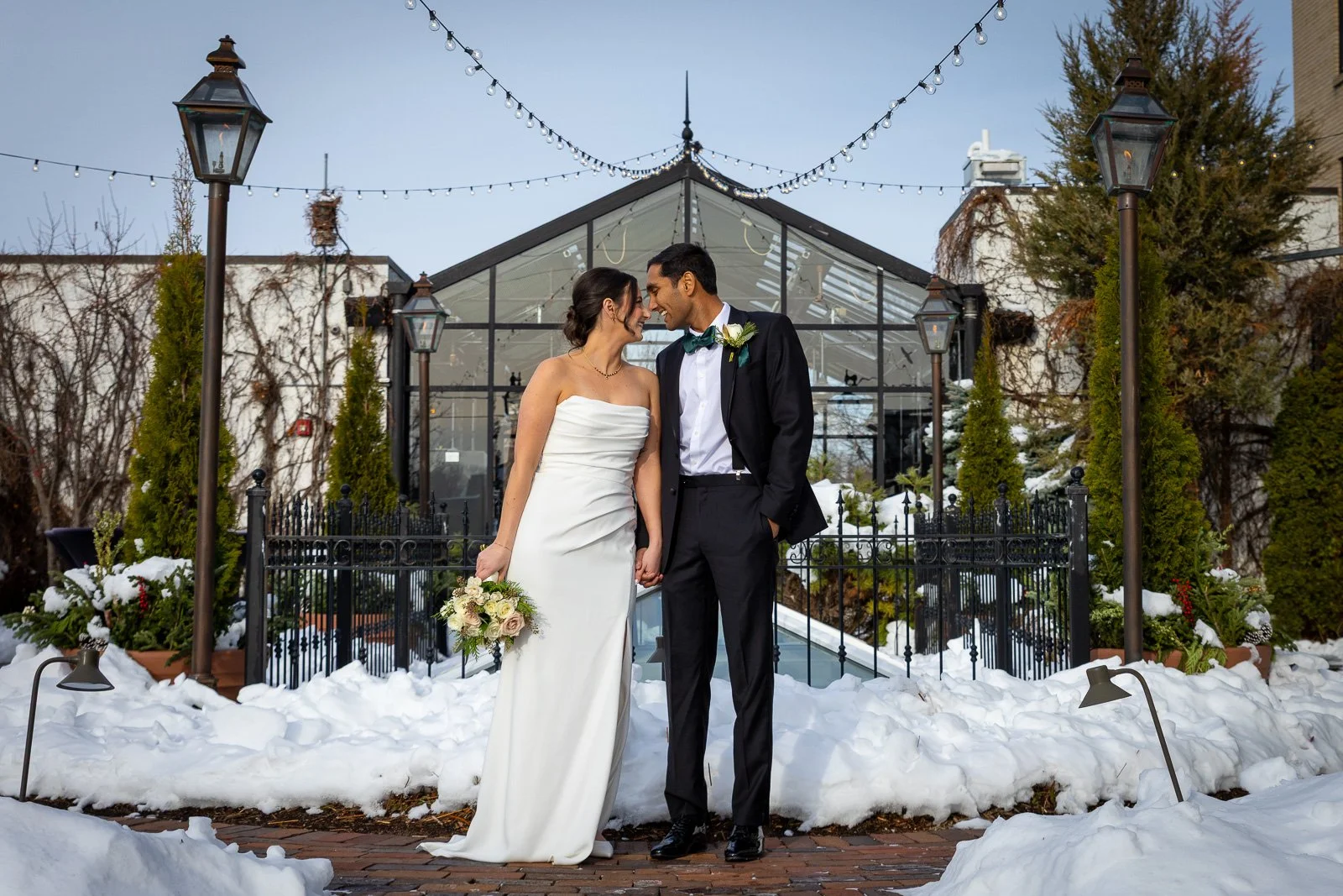 Newlyweds on The Atrium rooftop in Shorewood Wisconsin photographed by Milwaukee wedding photographer. Winter Wedding.