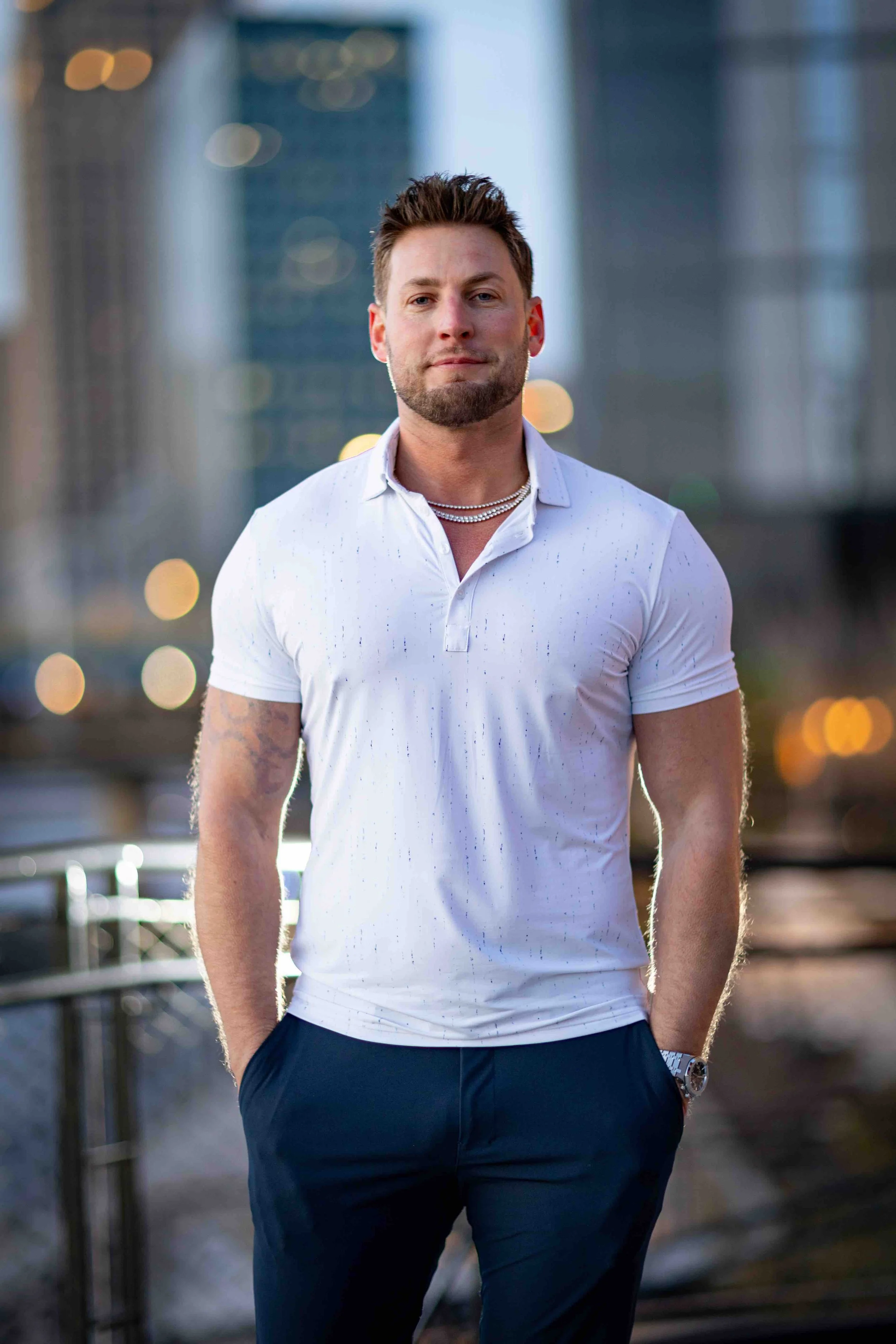 A man smiles for his headshot in Milwaukee, Wisconsin on the Riverwalk in the Third Ward