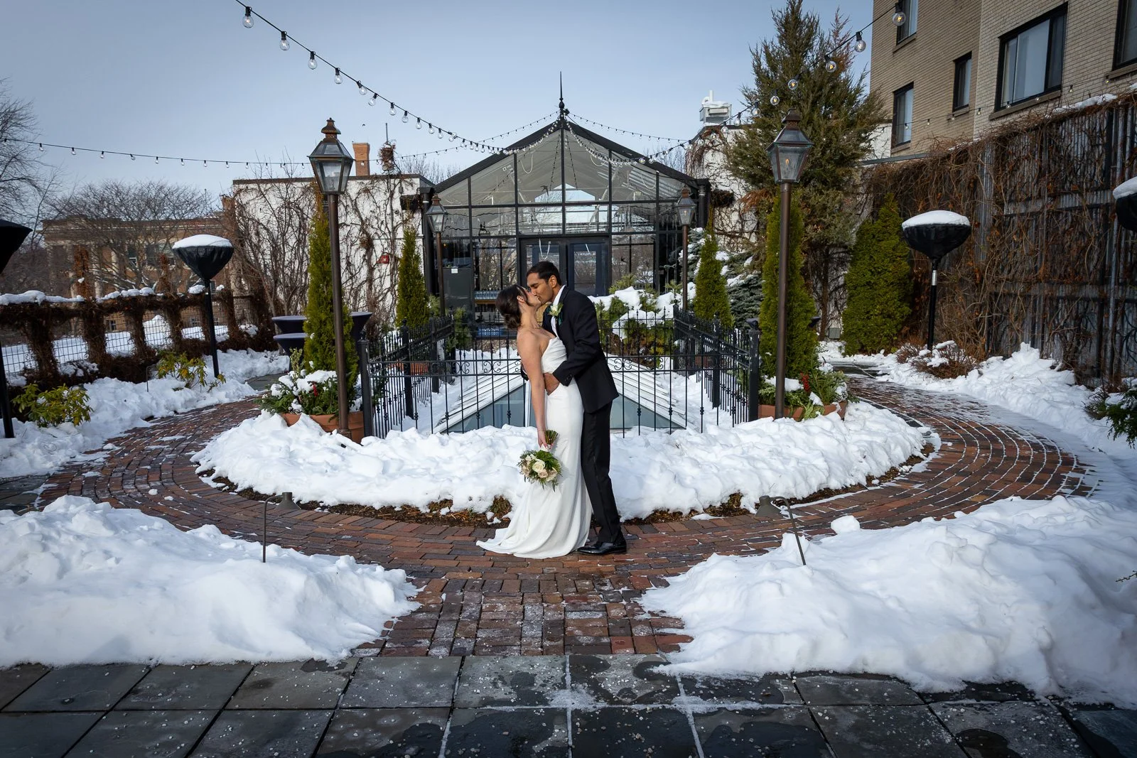 Newlyweds on The Atrium rooftop in Shorewood Wisconsin photographed by Milwaukee wedding photographer. Winter Wedding.