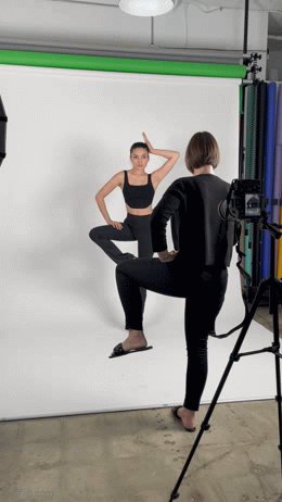 photographer shows a pose to a model