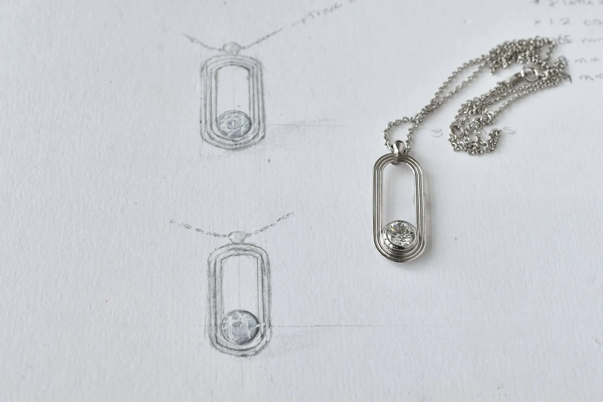 Diamond pendant shown alongside hand drawnings