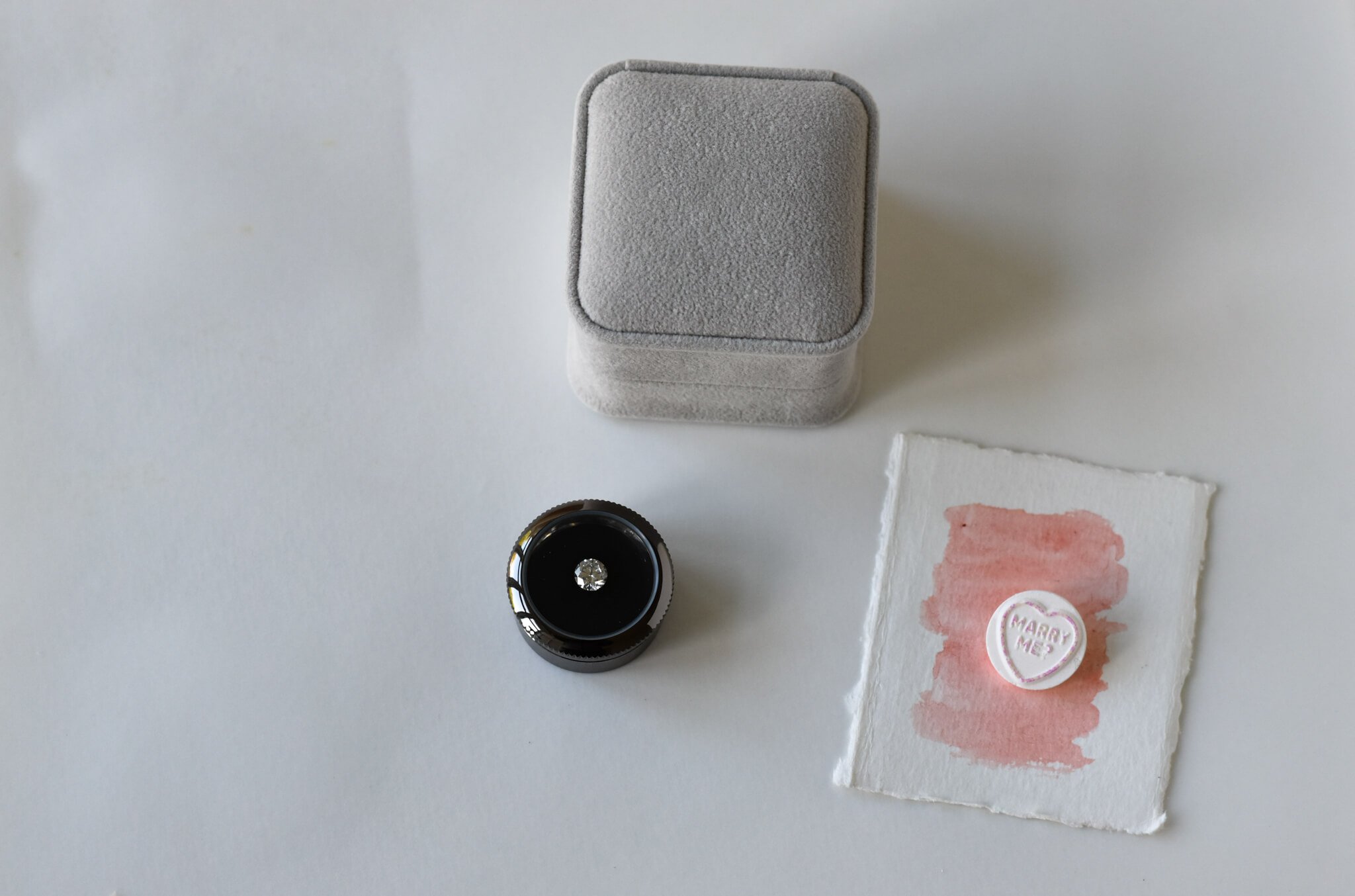 Diamond in a round box, grey wedding ring box and Marry Me heart candy