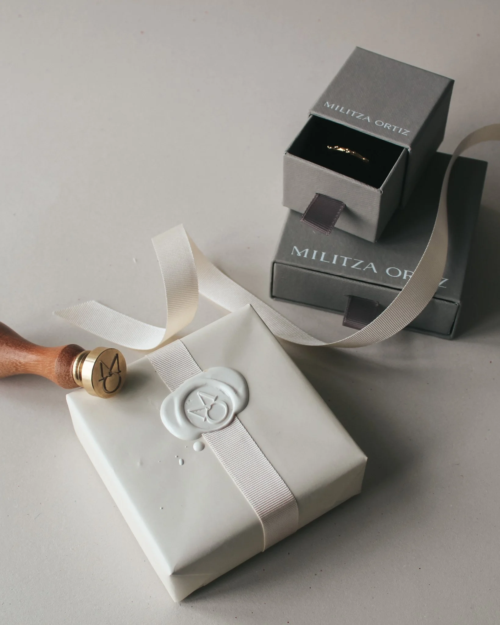 Wax seal and ribbon on Militza Ortiz gift packaging. Both boxes shown.