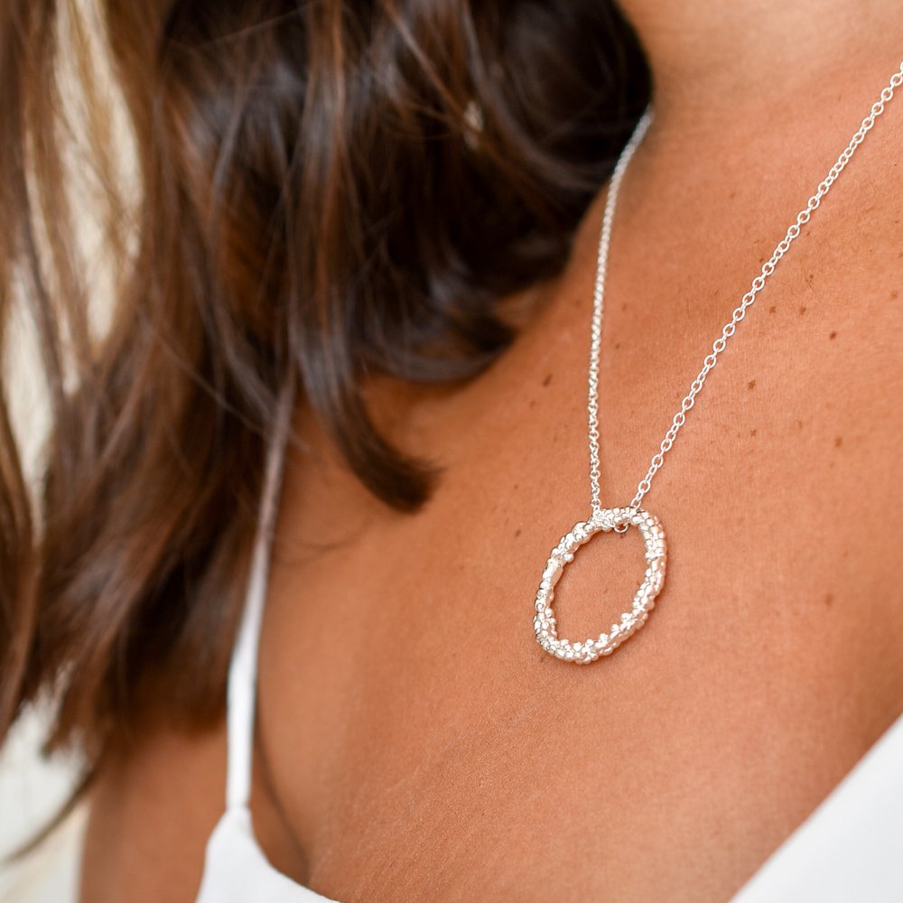 Circle pendant necklace - halo of bubble texture in sterling silver on silver chain on model - Militza Ortiz Jewellery