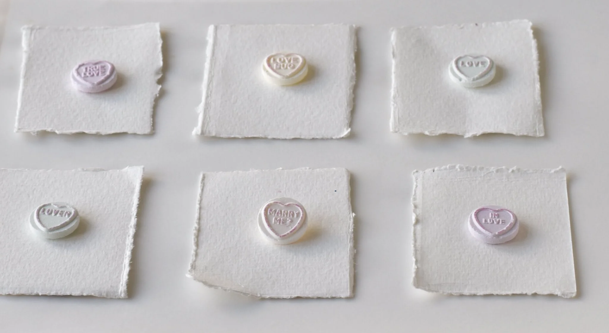 Heart love candies on individual paper