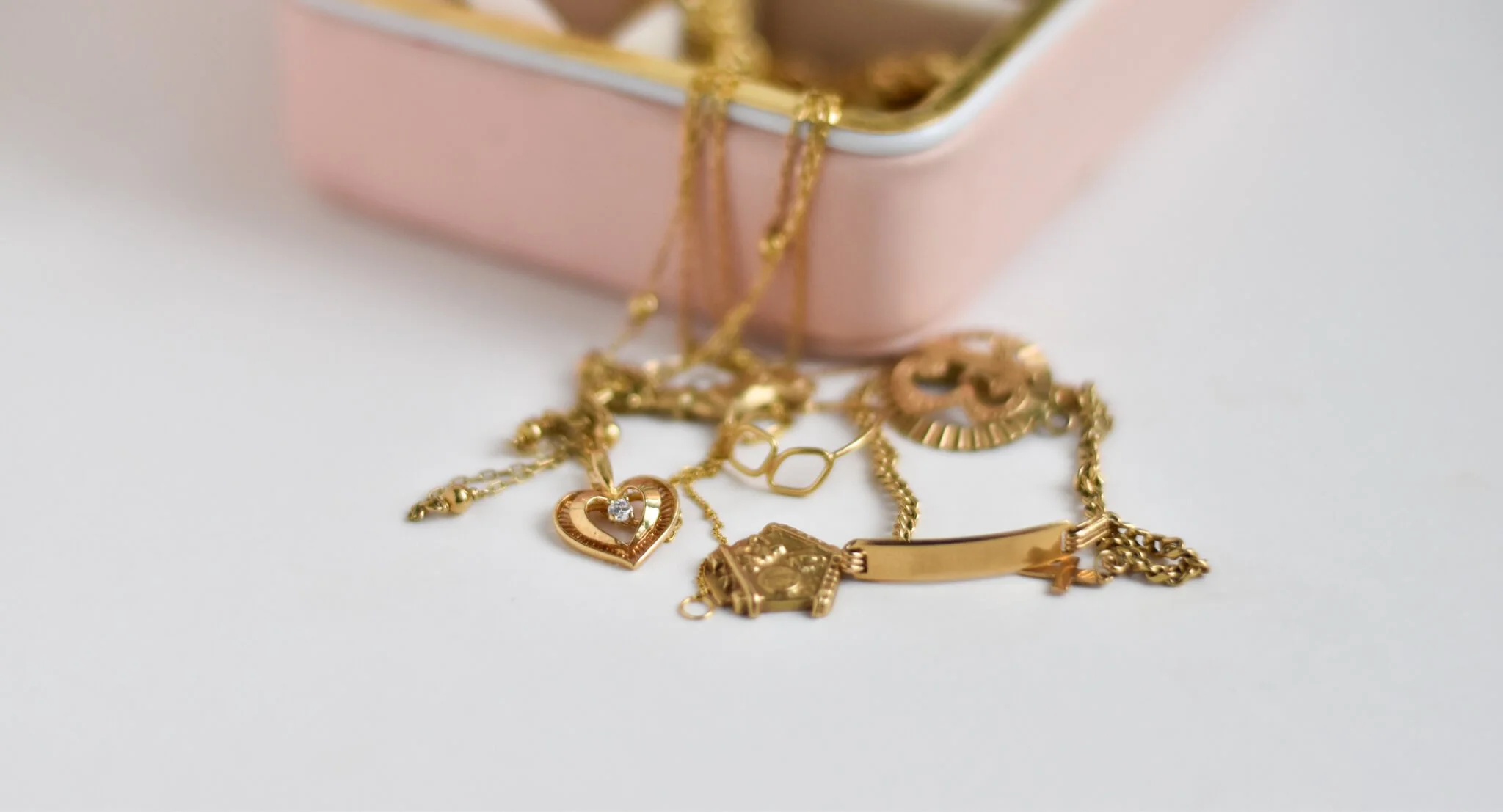 Gold jewellery coming out of pink jewellery case
