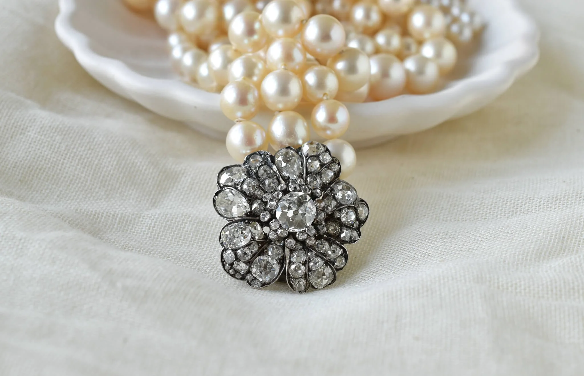 Clasp with diamonds, flower shaped with pearls in background