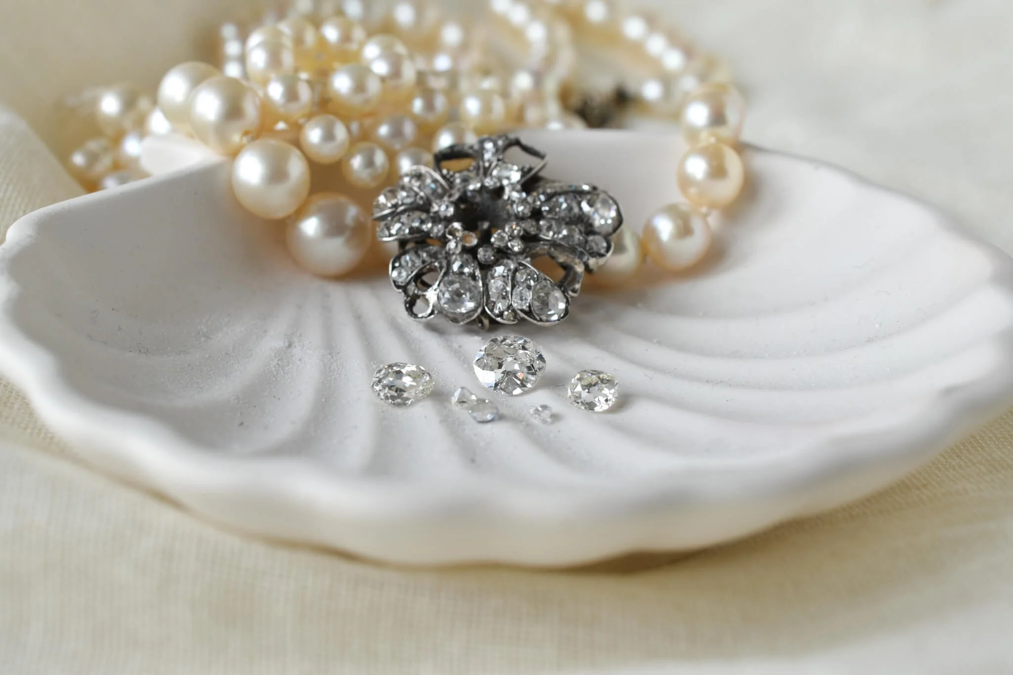 Diamonds removed from clasp on shell dish.