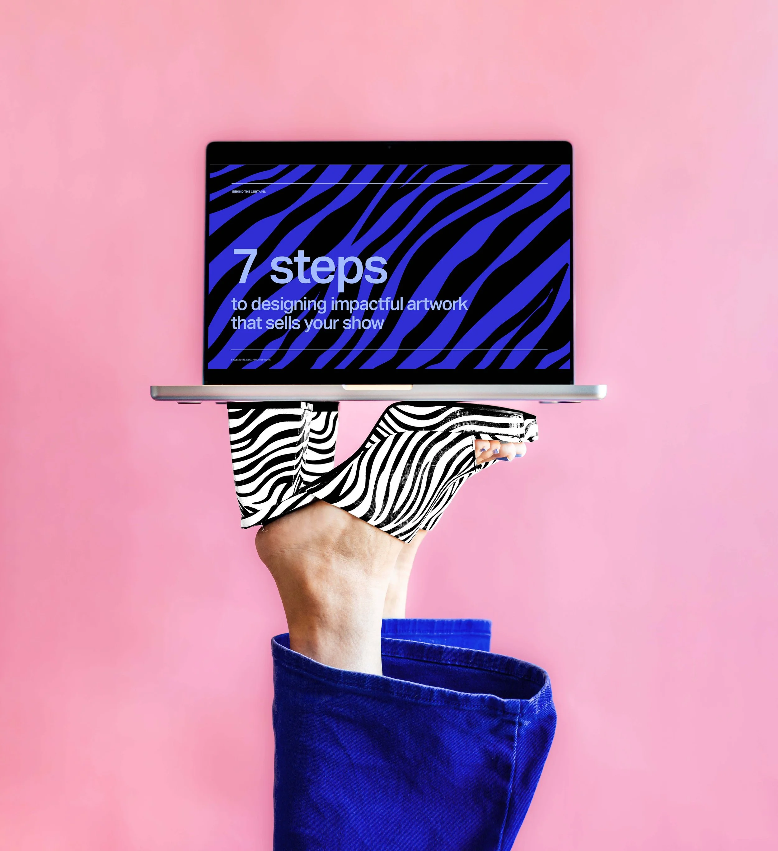 A person wearing a zebra-striped glove holding a laptop displaying the text '7 steps to designing impactful artwork that sells your show' against a pink background.