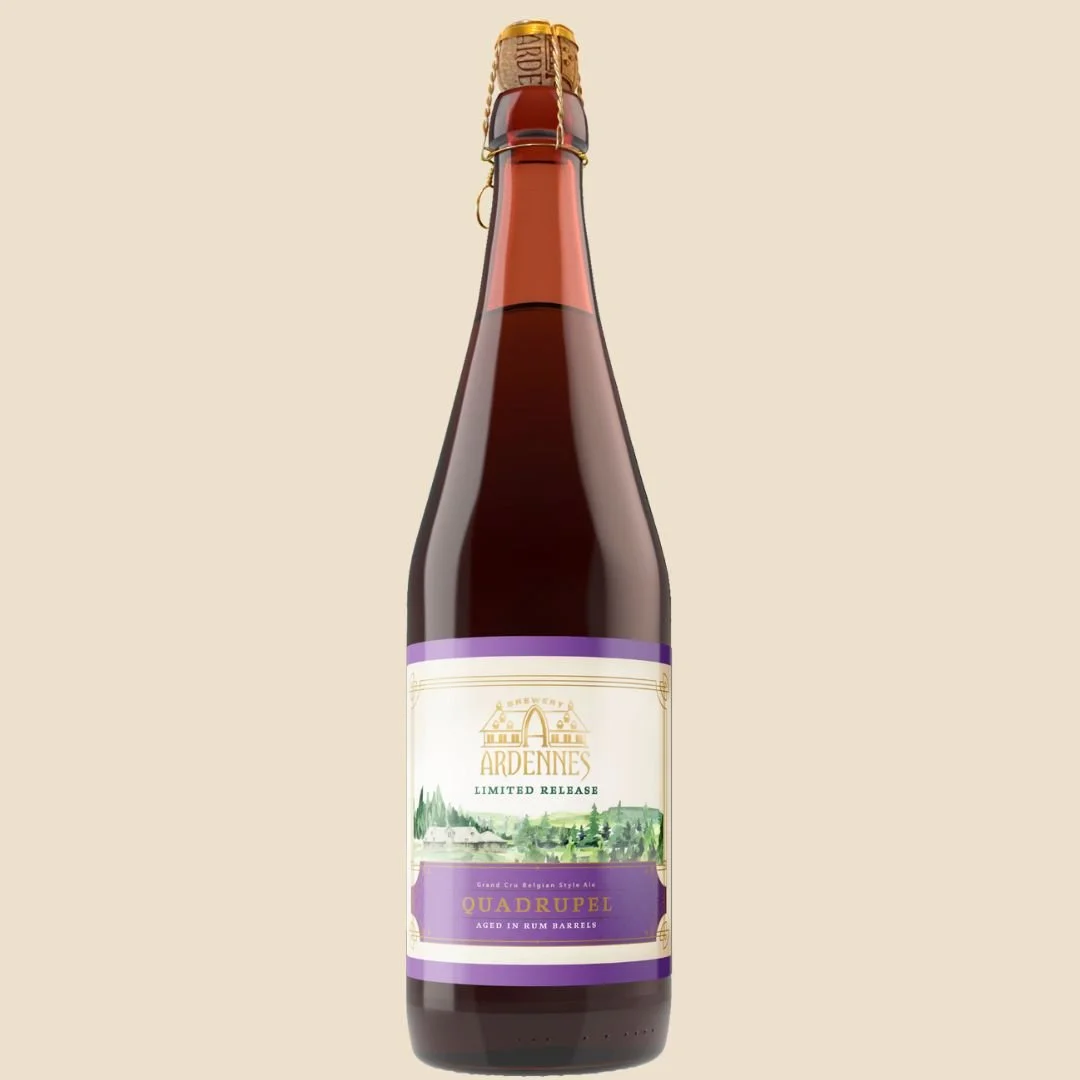 A bottle of Ardennes Limited Release Quadrupel Ale, aged in rum barrels with a purple label, against a beige background.