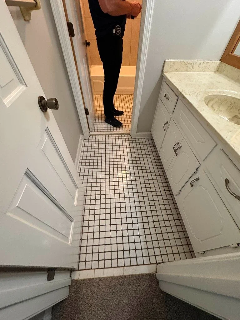 Before remodel. Poorly laid bathroom tile