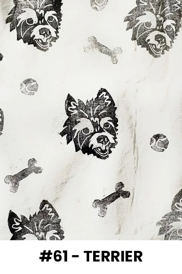 A pattern featuring black illustrations of a terrier dog's face, scattered with small bones and dog paw prints on a light background.