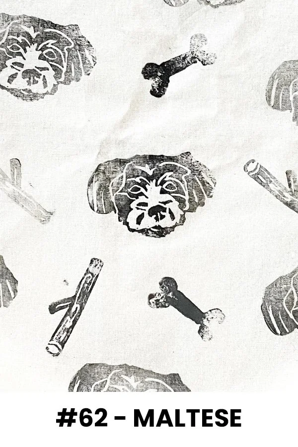 Black and white pattern with dog faces, sticks, and bones, labeled #62 - Maltese.