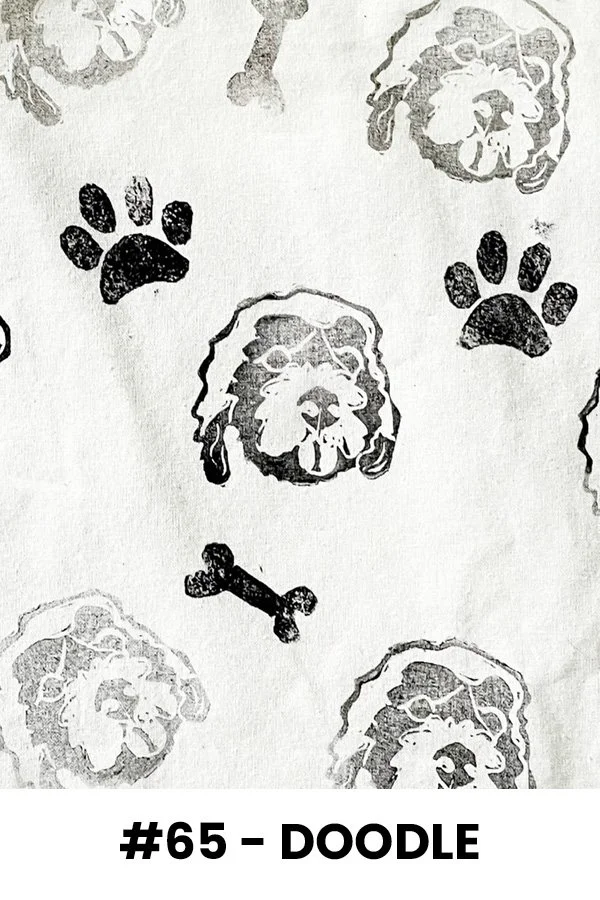 Pattern of dog faces, paw prints, and bones in black on white background, labeled '#65 - DOODLE'.