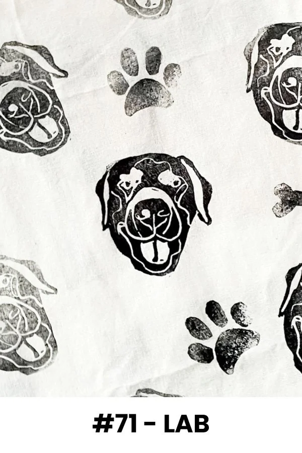 Pattern of black and white dog faces and paw prints on fabric or paper, labeled #71 - LAB