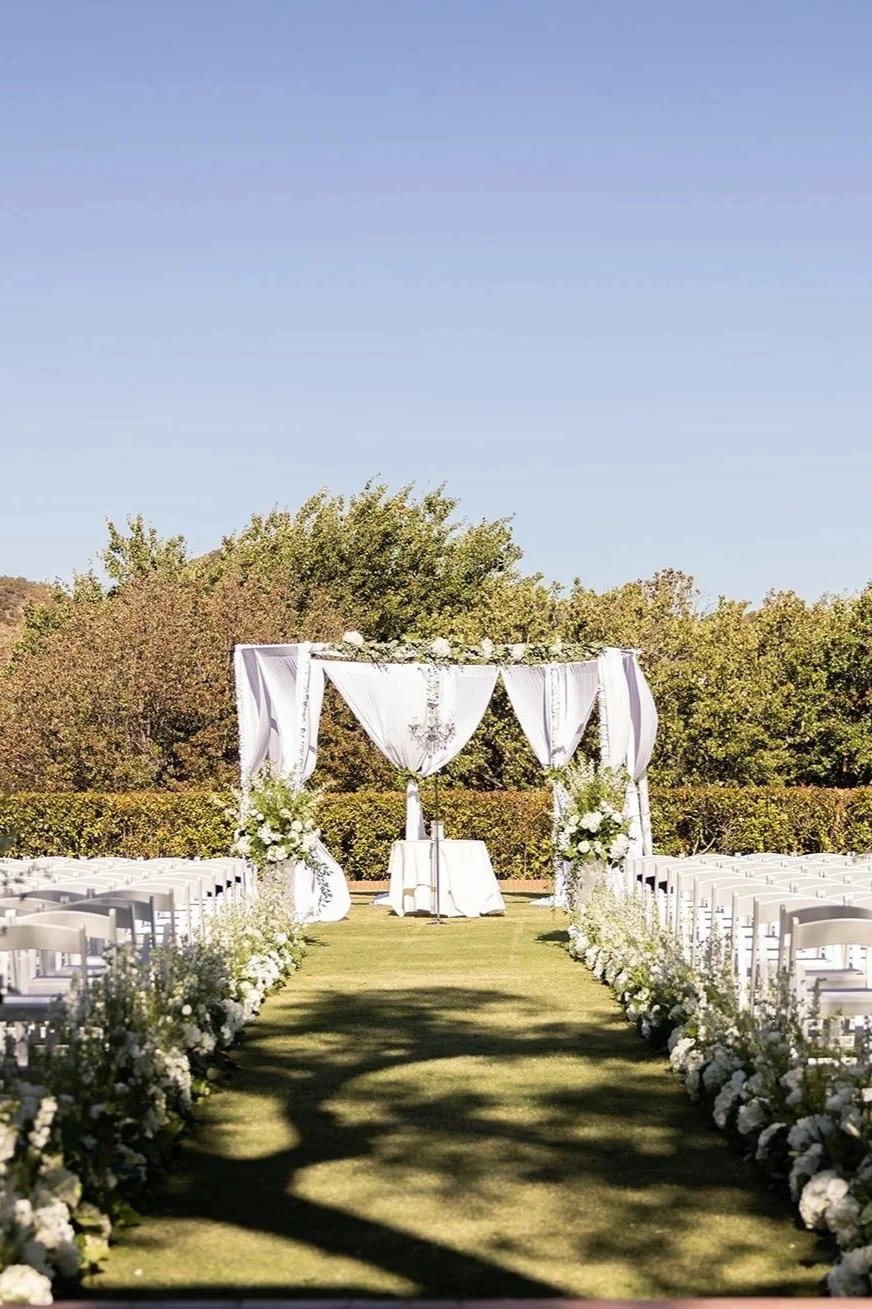 White floral ceremony aisle design at Sherwood Country Club wedding in Sherman Oaks, California