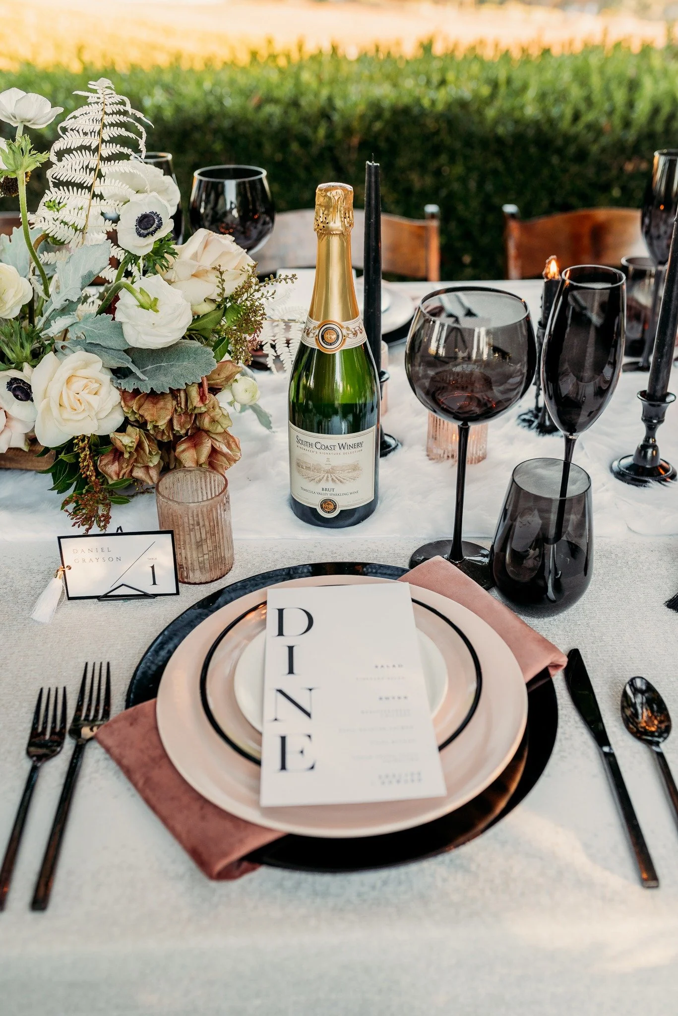 Elegant table setting detail at South Coast Winery fall wedding editorial with layered place setting and candlelight