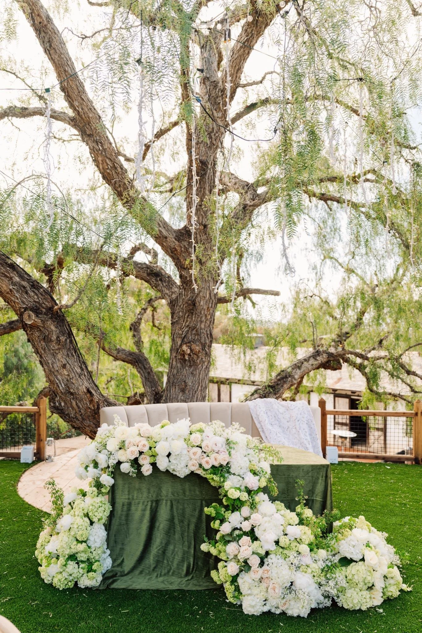 Sweetheart table with lush, cascading floral installation at private estate wedding in Rolling Hills Estates, Los Angeles