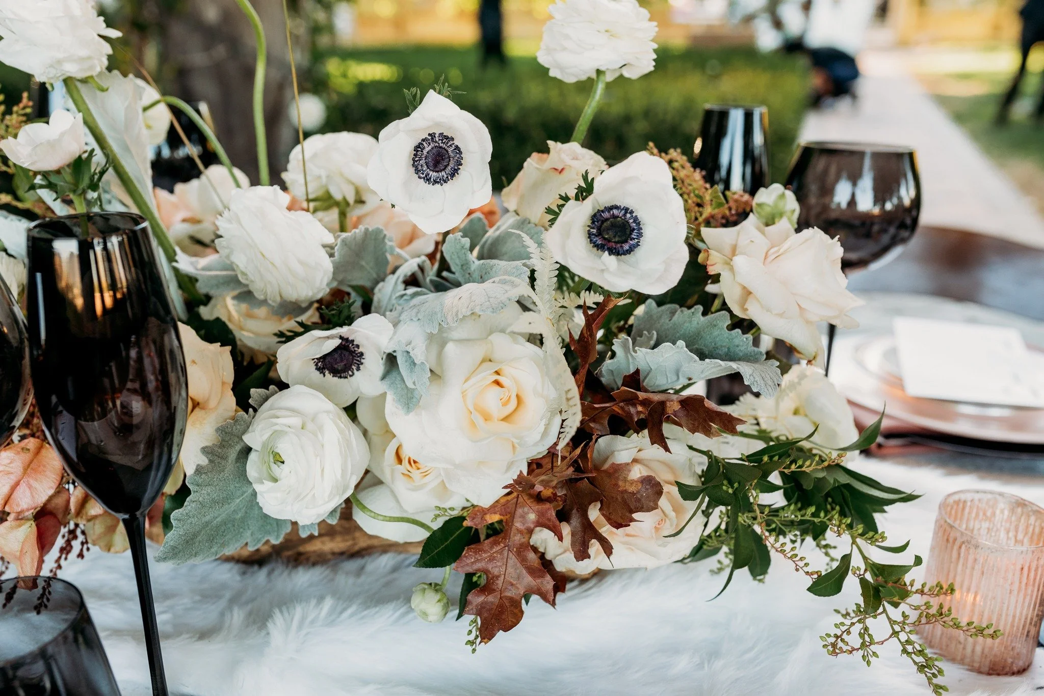 Close-up of floral centerpiece with white blooms at South Coast Winery fall vineyard wedding editorial
