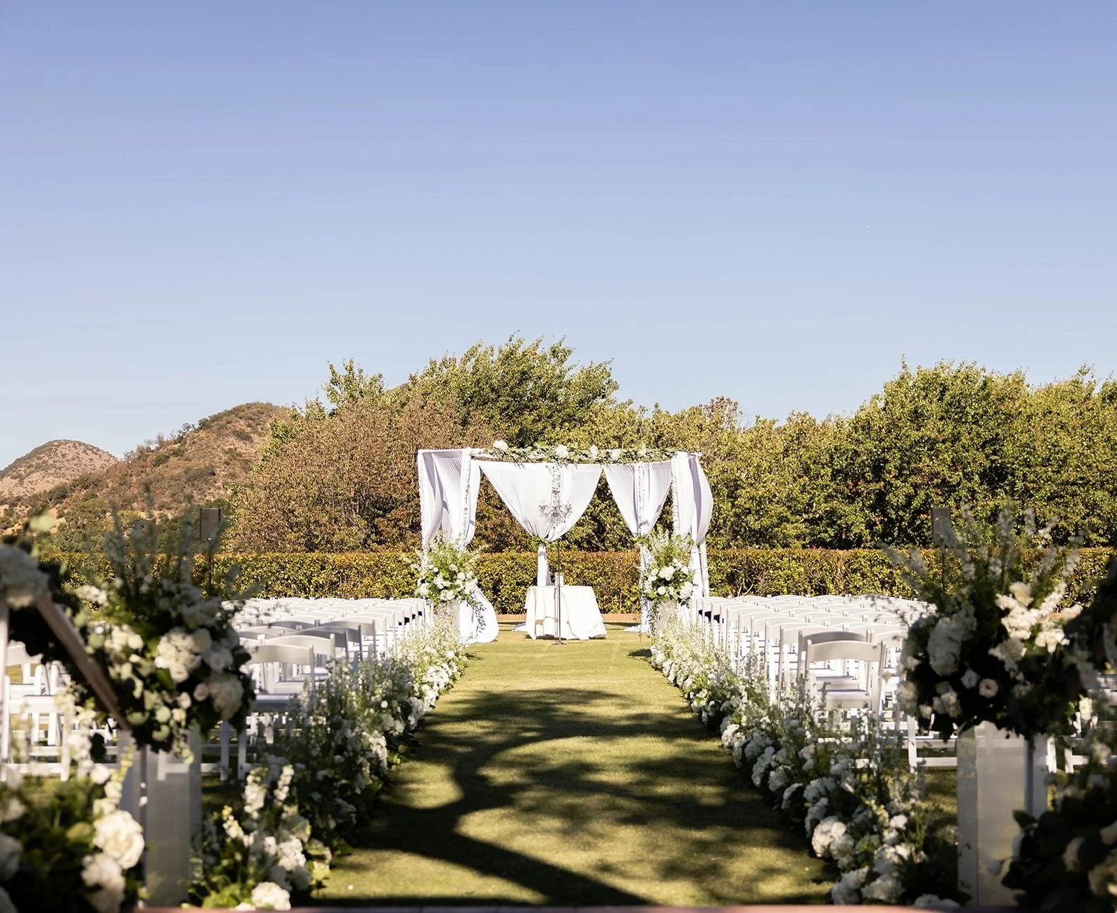 White floral ceremony aisle design at Sherwood Country Club wedding in Sherman Oaks, California