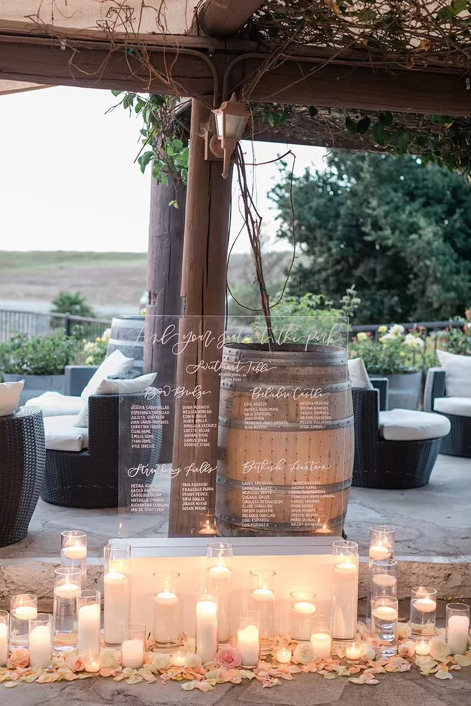 Romantic escort card display with candles and acrylic seating chart at Callaway Winery Temecula wedding
