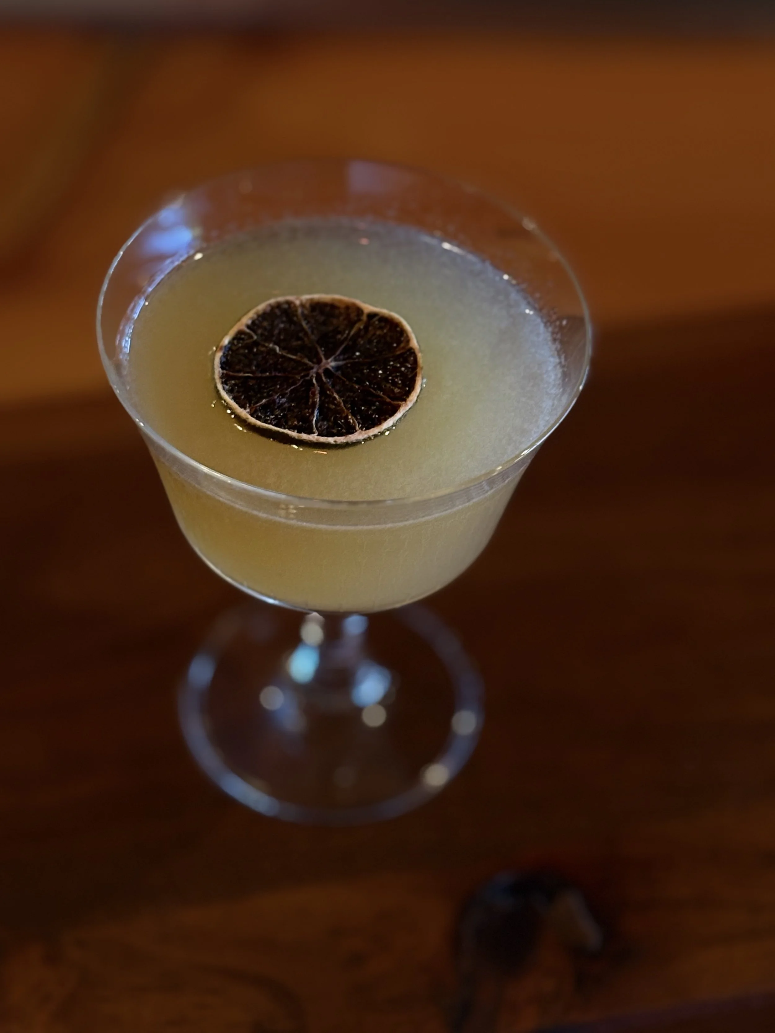 craft cocktail with banana and lime wheel 