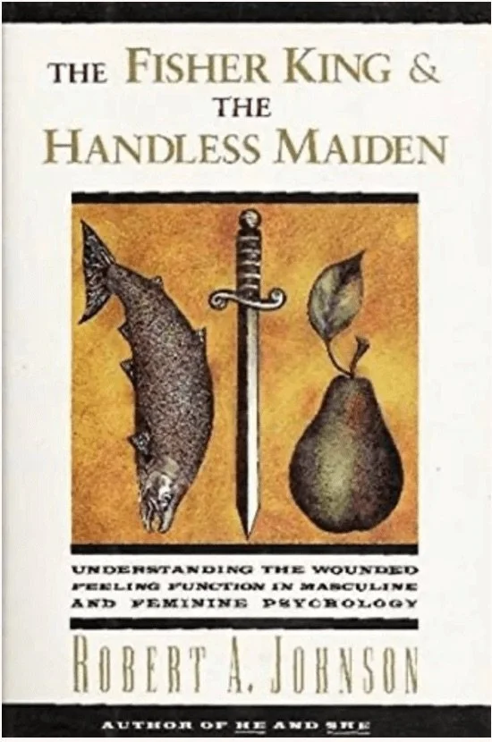 Book cover titled 'The Fisher King & The Handless Maiden' by Robert A. Johnson, featuring an illustration of a fish on the left, a dagger in the center, and a pear on the right.
