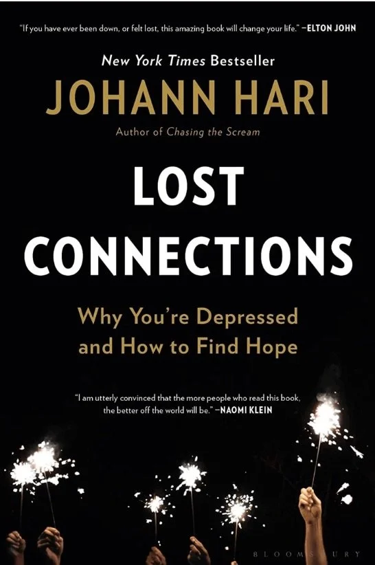 Book cover for 'Lost Connections' by Johann Hari, featuring silhouettes of hands holding sparklers against a black background, with quotes praising the book at the top and bottom.