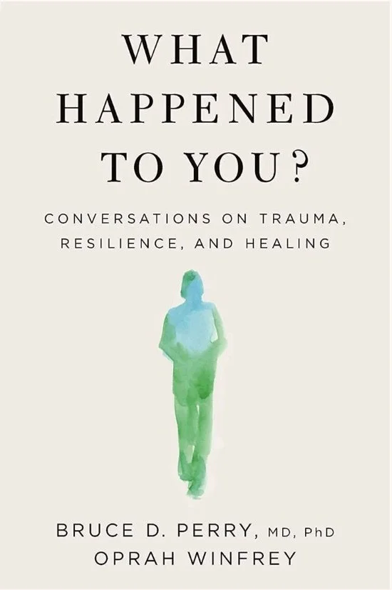 Book cover titled "What Happened to You?" with subtitle "Conversations on Trauma, Resilience, and Healing" by Bruce D. Perry, MD, PhD, and Oprah Winfrey, featuring a watercolor silhouette of a woman in blue and green.
