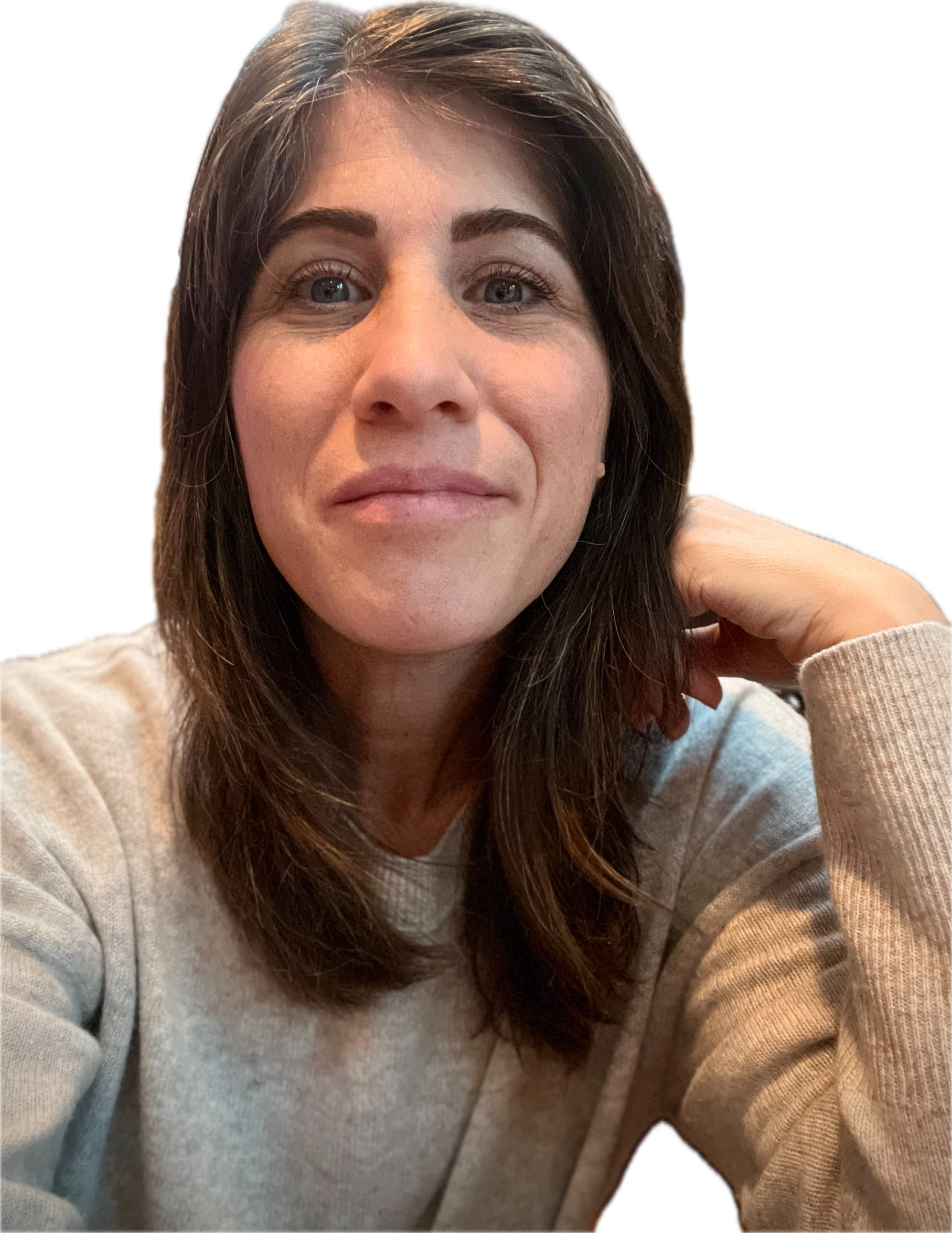 Person with brown hair in a casual setting, wearing a light sweater.