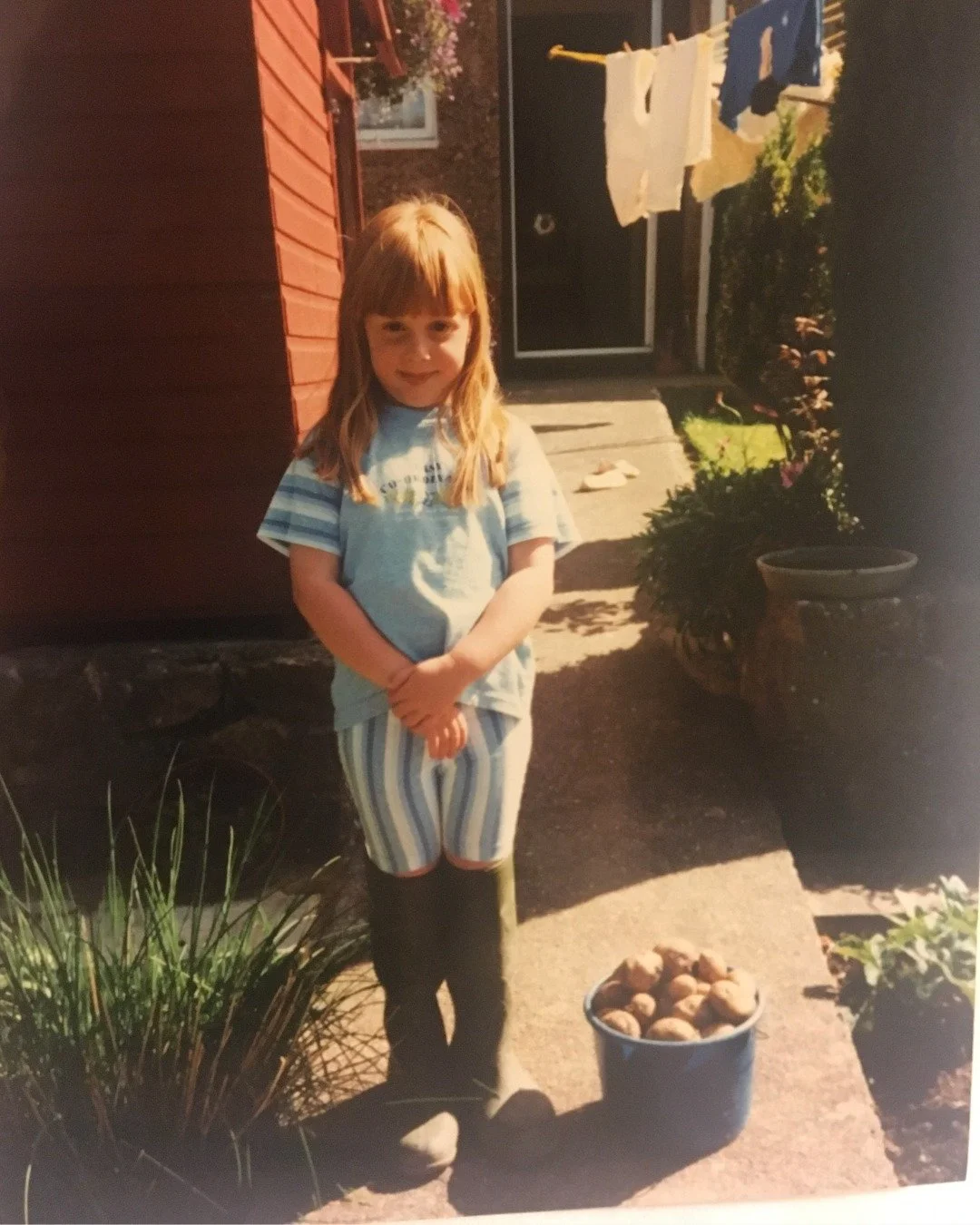 This photo is of me as a little girl wearing my grandad's wellies. I remember following him around the garden, determined to help him with whatever he was doing, even though the boots were far too big.

Looking back, maybe I've always been trying to 