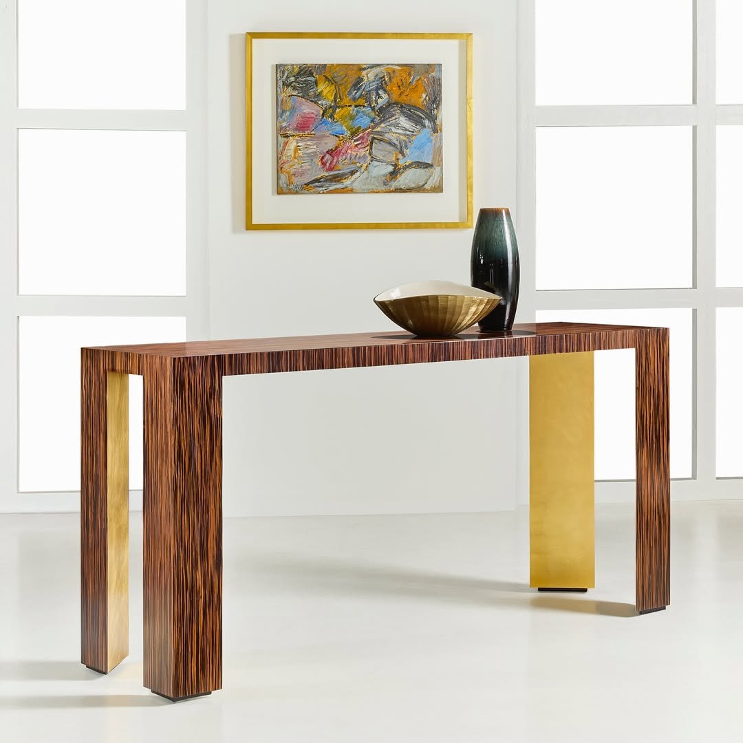 Radiant in form and finish.

The Paloma Rosewood Console by @modernhistoryfurniture pairs sculptural simplicity with bold wood grain, finished with a subtle golden glow. A modern silhouette with a timeless presence&mdash;designed to anchor the space 