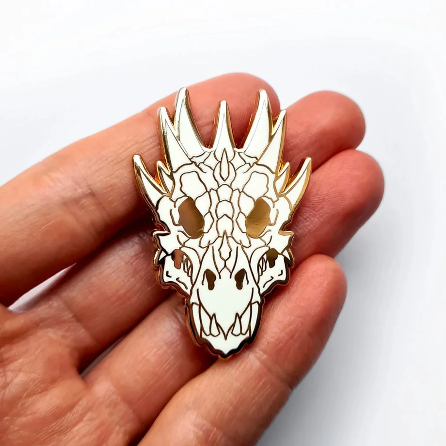 Tattoo-style dragon skull enamel pin with demonic fantasy design