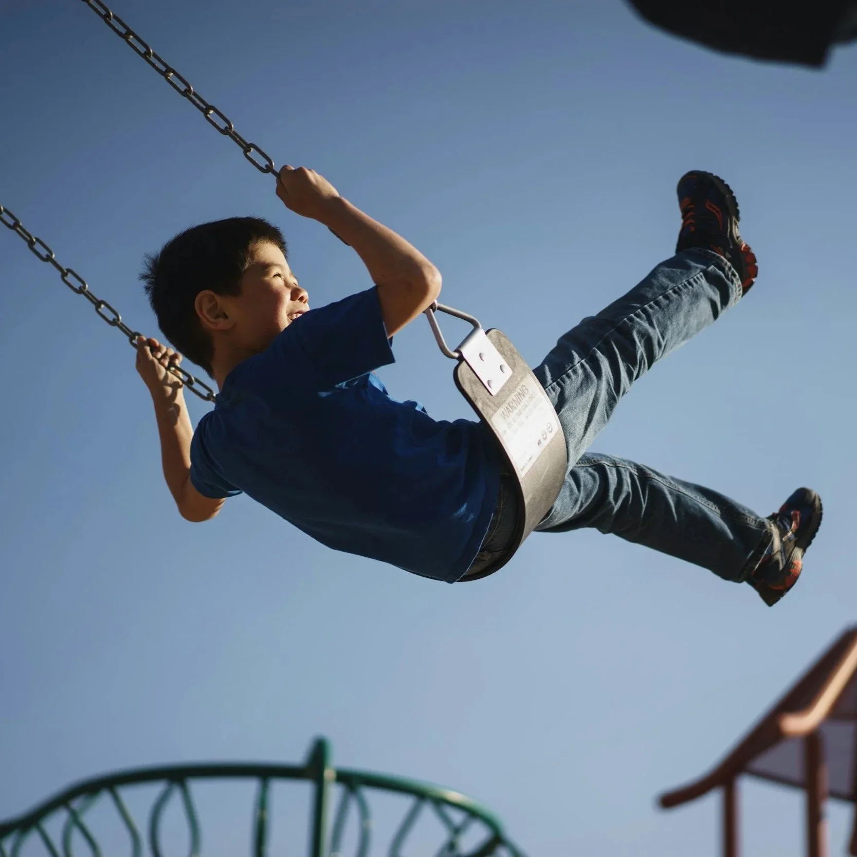 School boy on swing