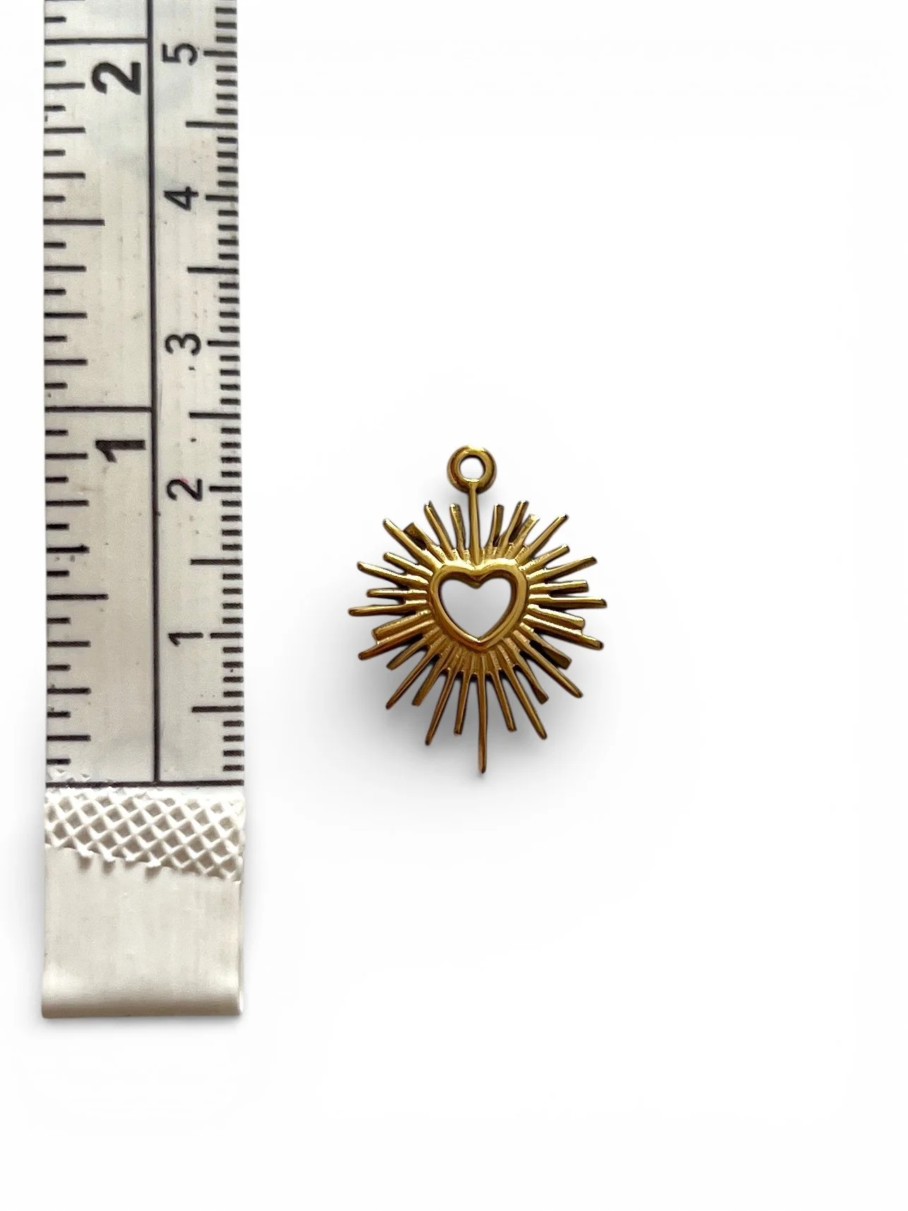 gold radiant heart charm with center cutout
