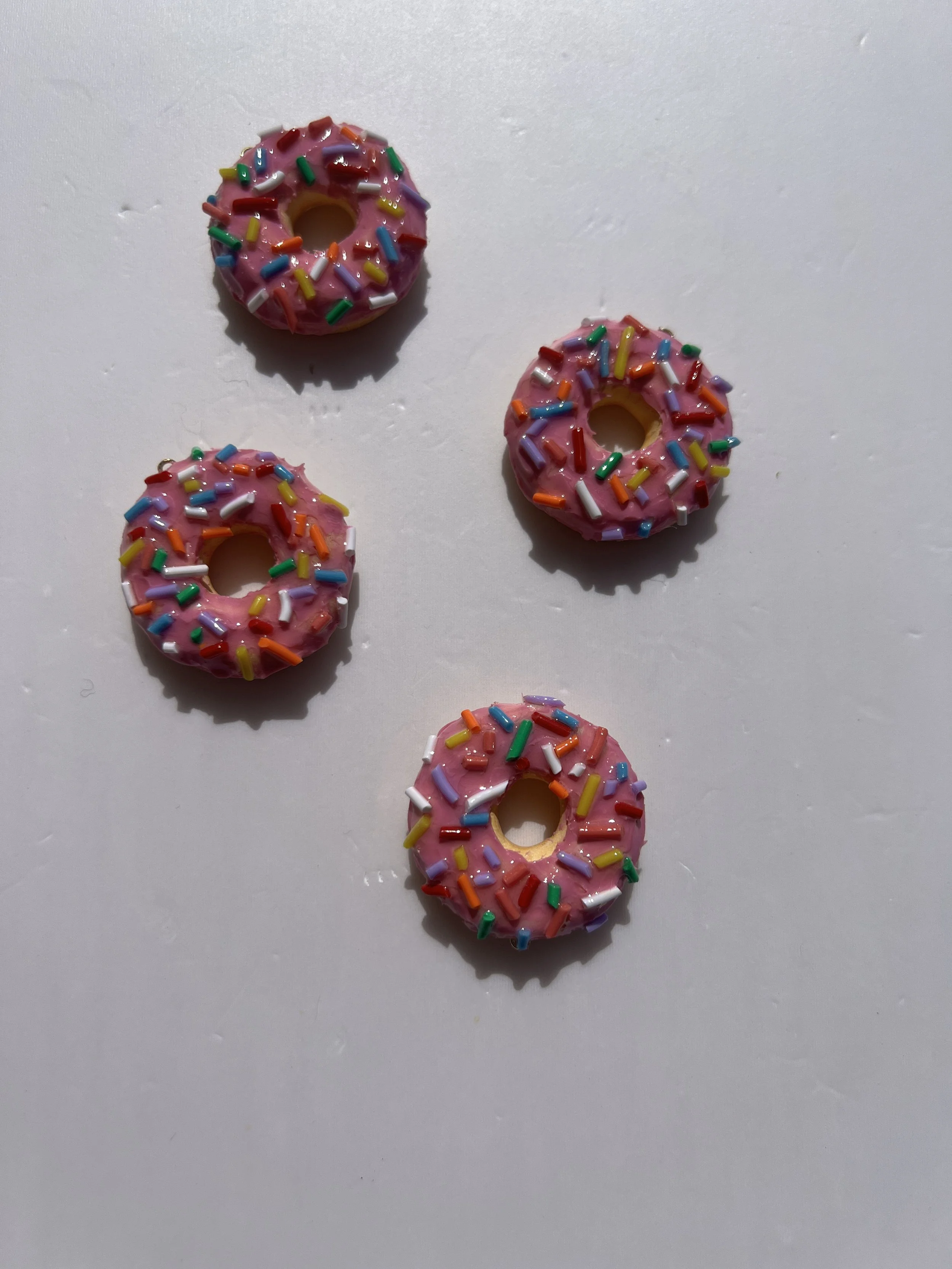 handmade donut charm with pink icing and sprinkles
