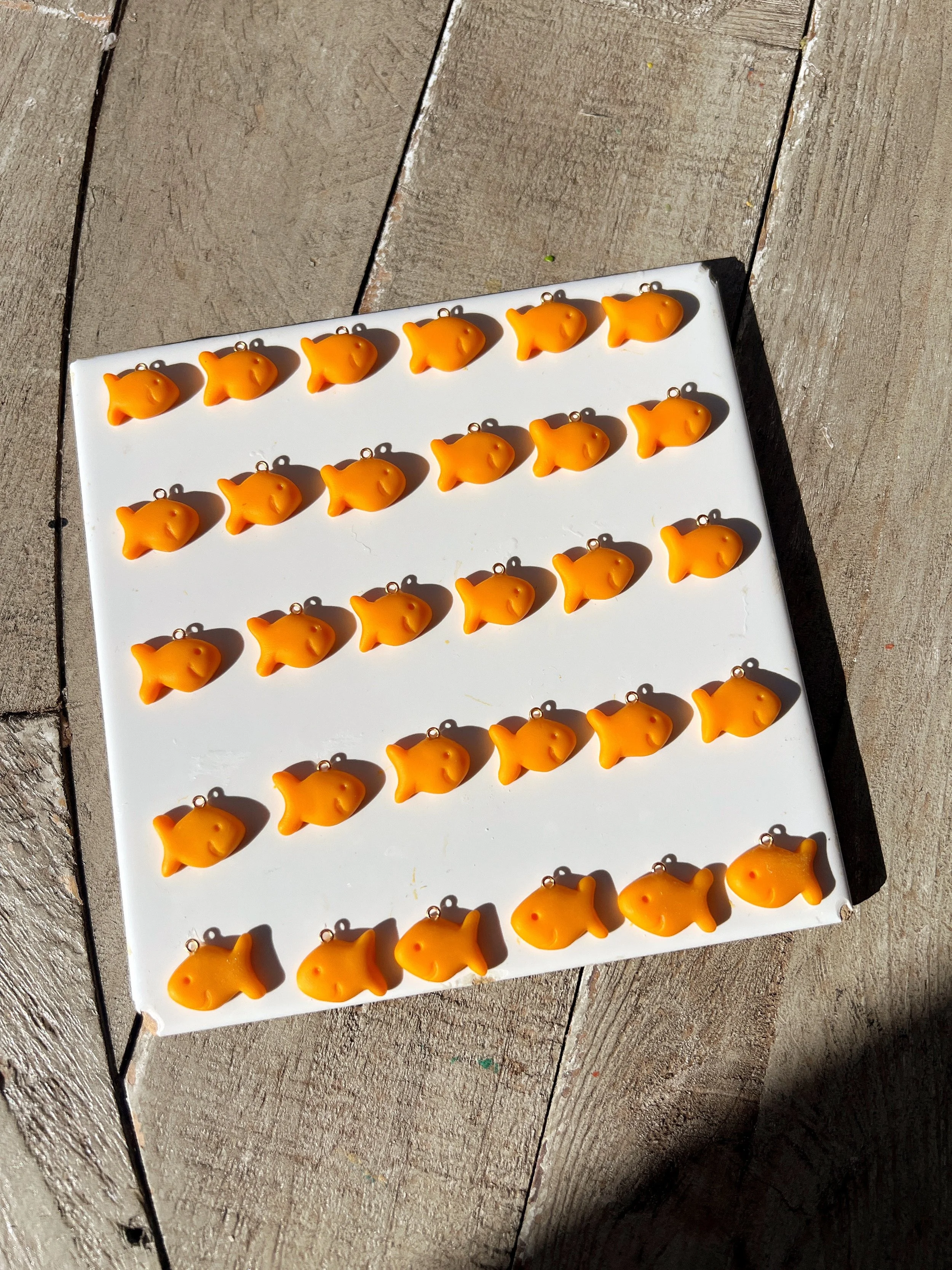 mini handmade goldfish charms on tray