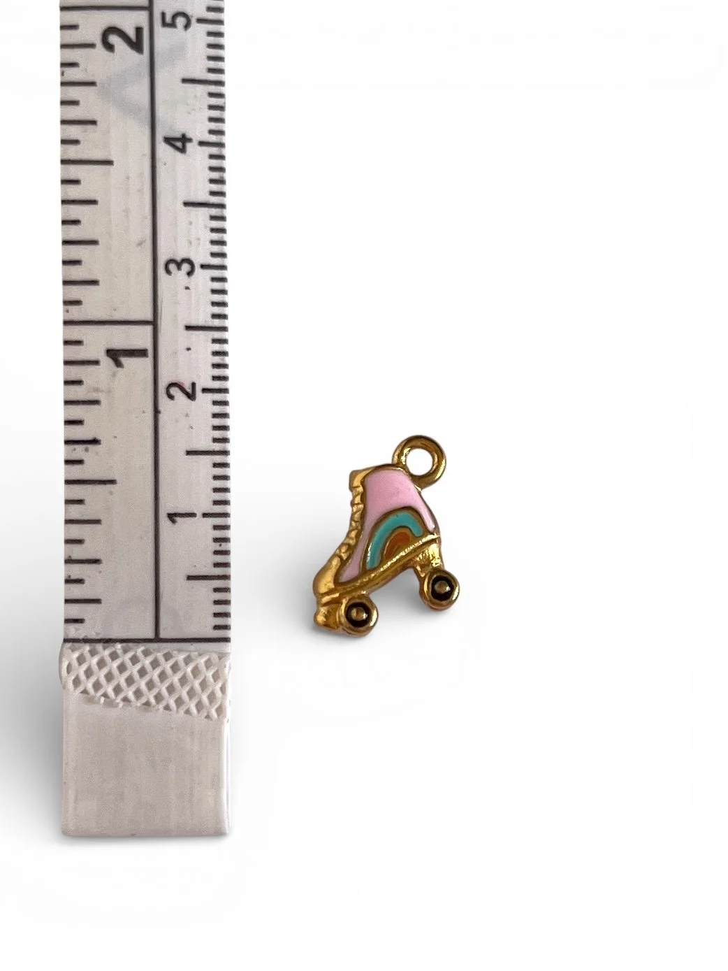 Pink and gold roller skate charm with enamel details